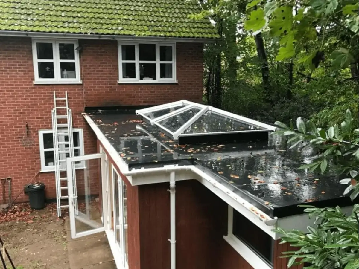 Completed flat roof extension featuring crisp white uPVC guttering and twin decorative skylight roof lanterns. Installed by Norfolk Exterior Solutions
